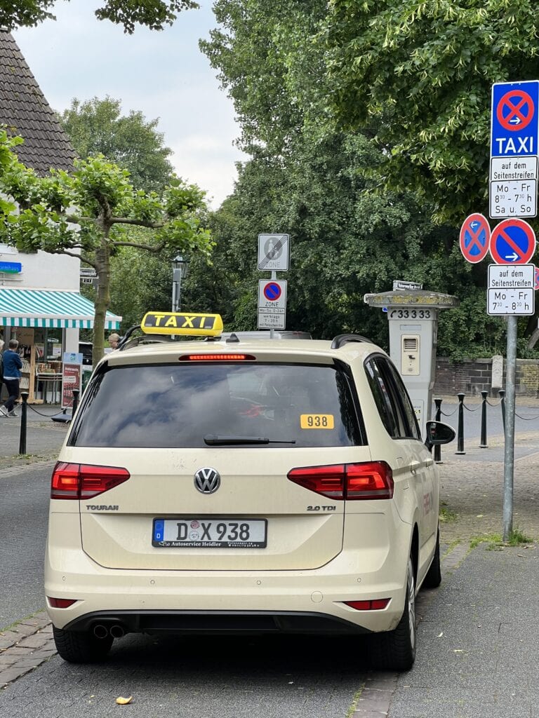 A taxi in Germany waiting at a taxi stand.